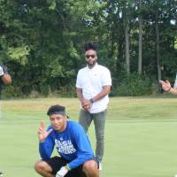 four lakers posing together on the golf course